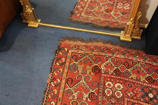 A large Persian carpet, 20ft 8in by 8ft 6in.